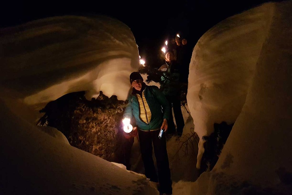A Torch-Lit Evening on Snowshoes Followed by Dinner at a Mountain Lodge