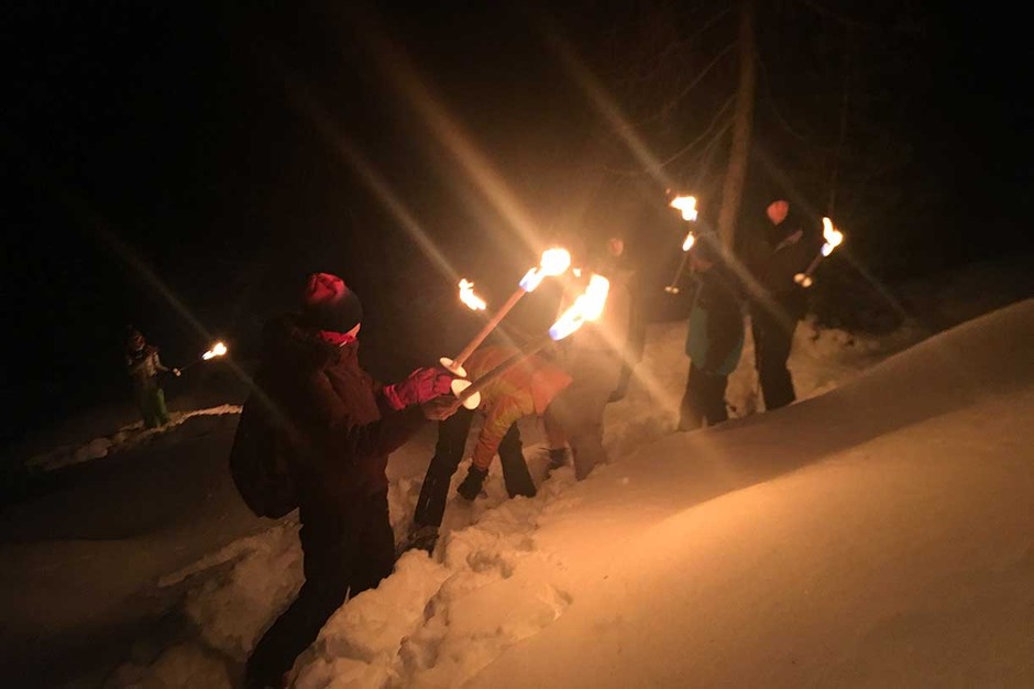 A Torch-Lit Evening on Snowshoes Followed by Dinner at a Mountain Lodge