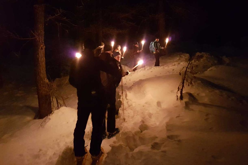 A Torch-Lit Evening on Snowshoes Followed by Dinner at a Mountain Lodge